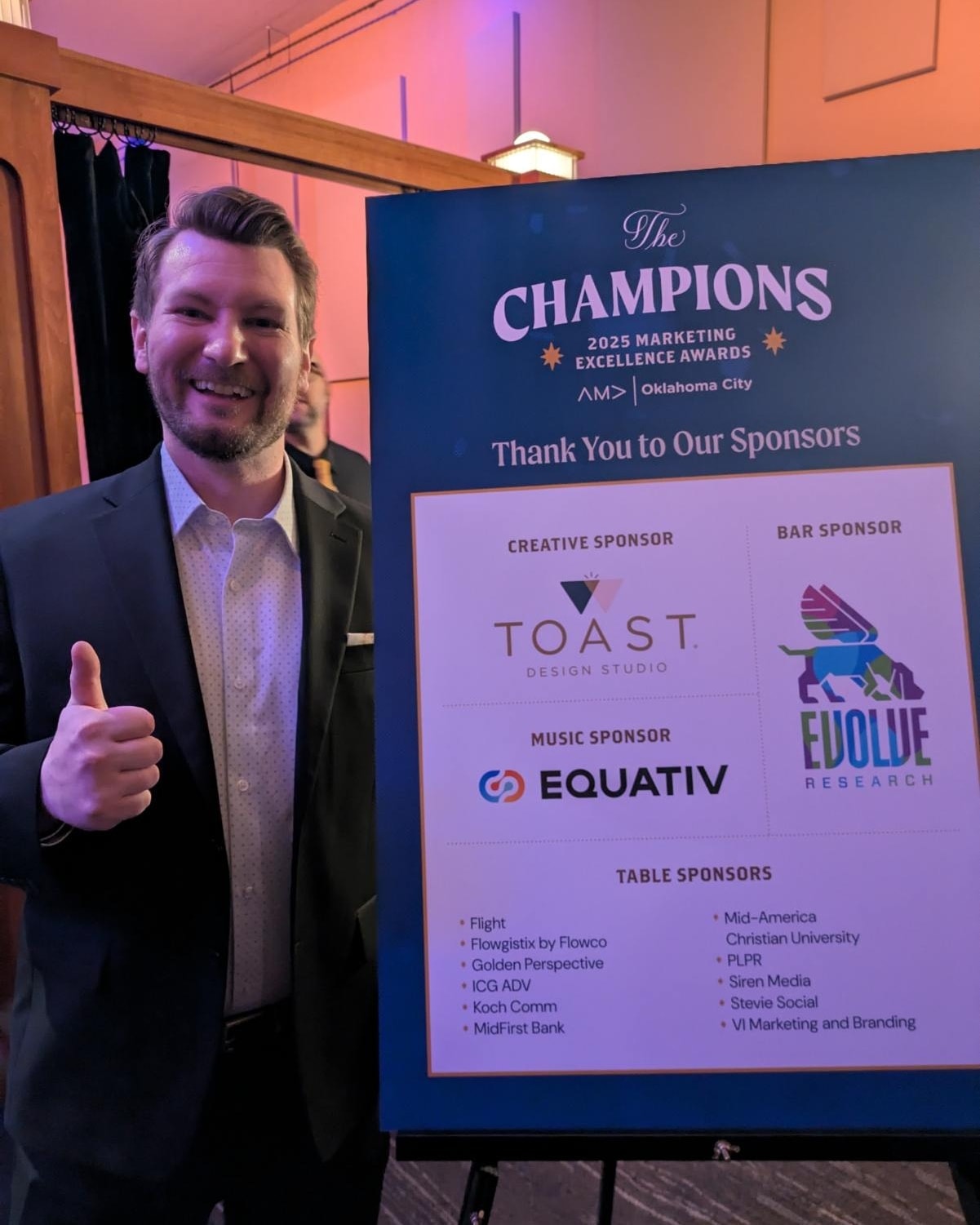 Garrett Hammonds holding the award-winning campaign poster
